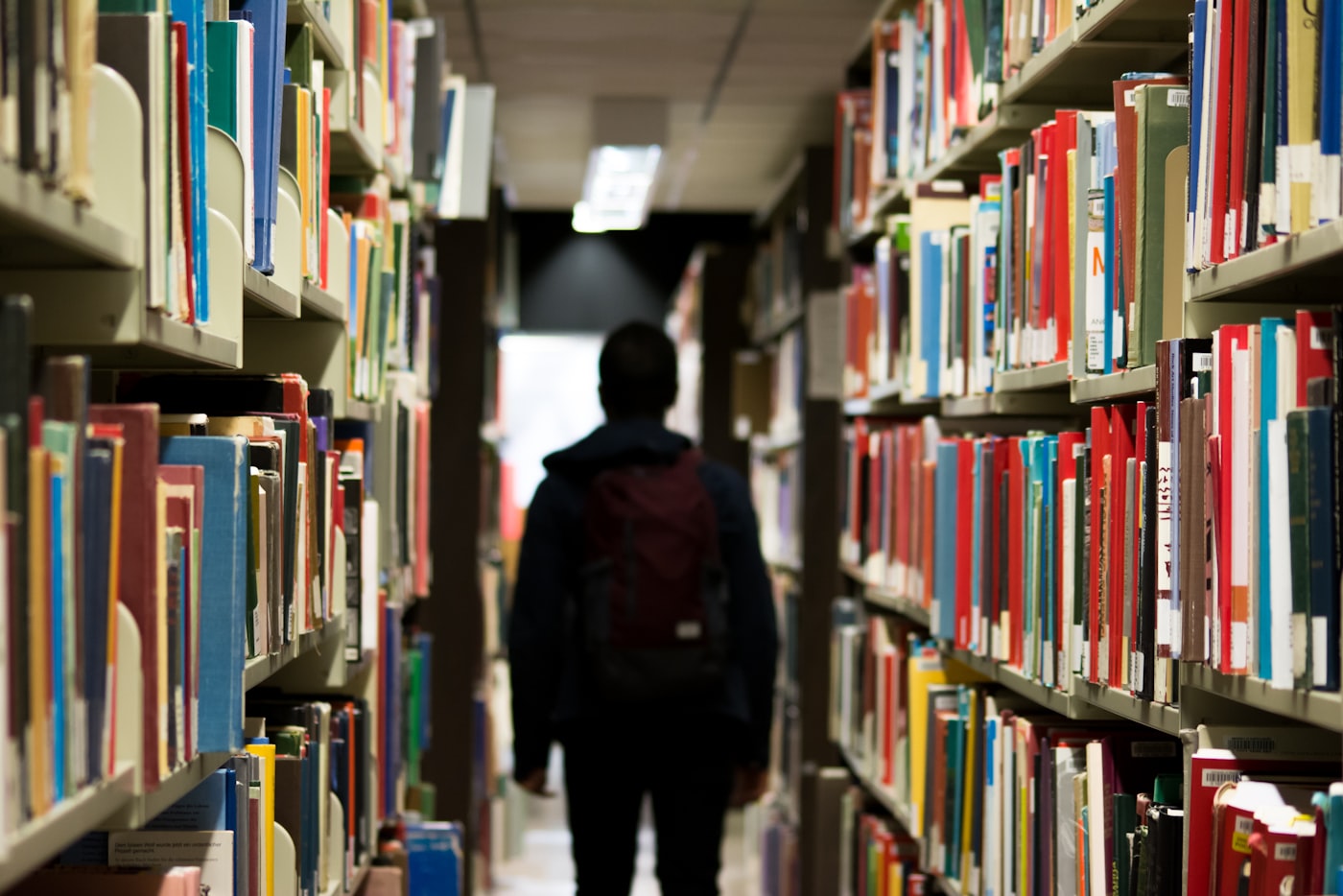 A student walking through a library